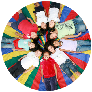 Schoolchildren laying on the ground in a circle