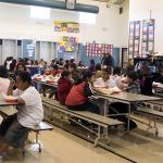 A school cafeteria with children eating