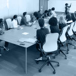 A table of students watching an instructor