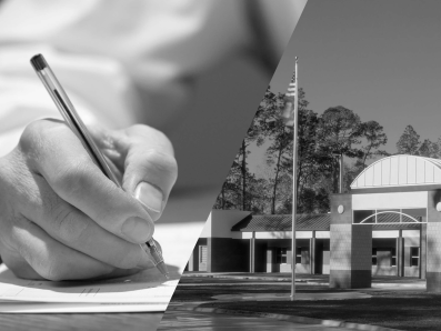 A hand holding a pencil and writing on paper alongside a public health department buildiing