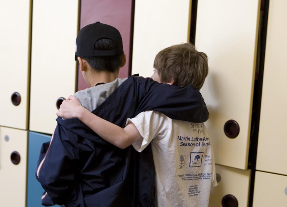 Two school children with their arms around each other