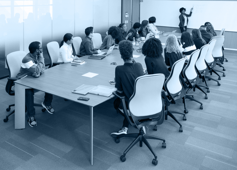 A table of students watching an instructor