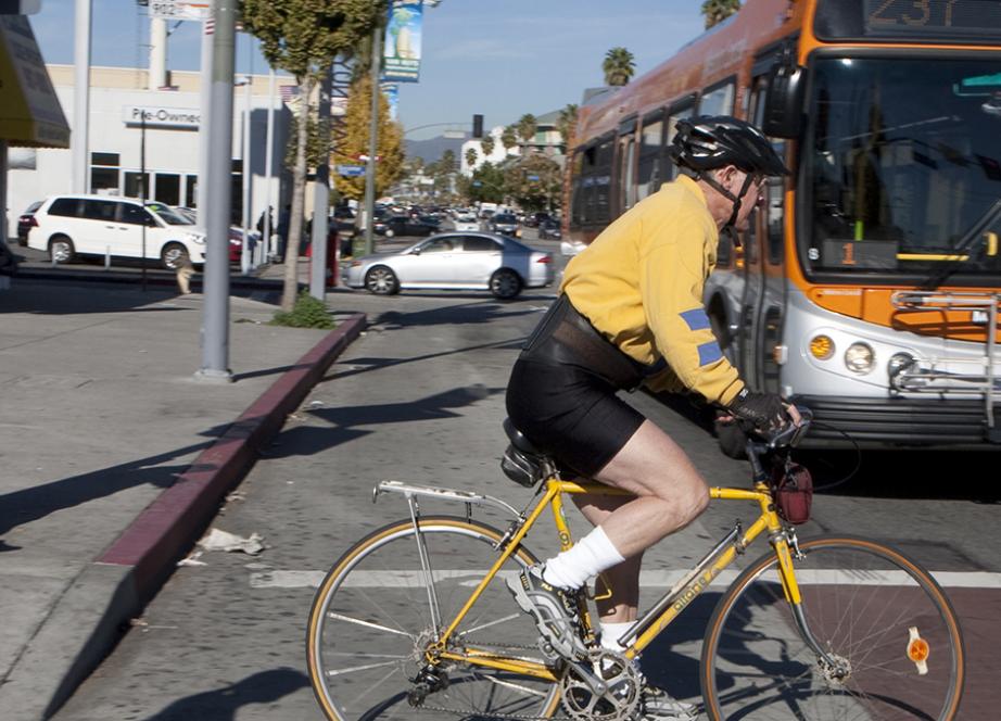 Pedestrians and a cyclist crossing a city street