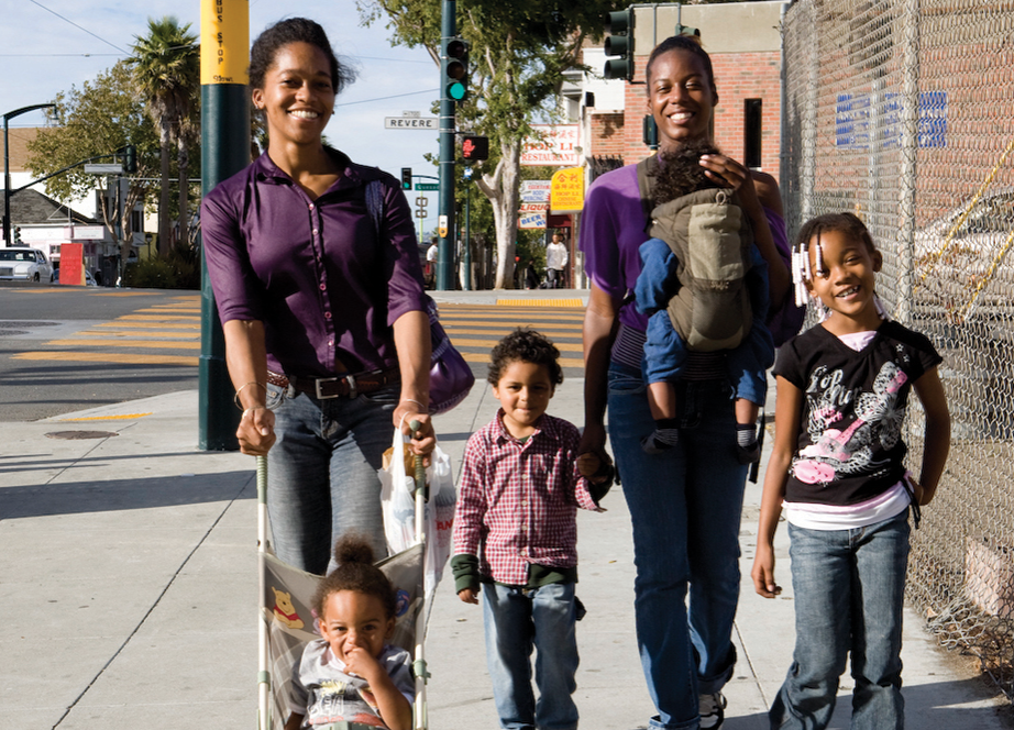 Parents and small children walking together