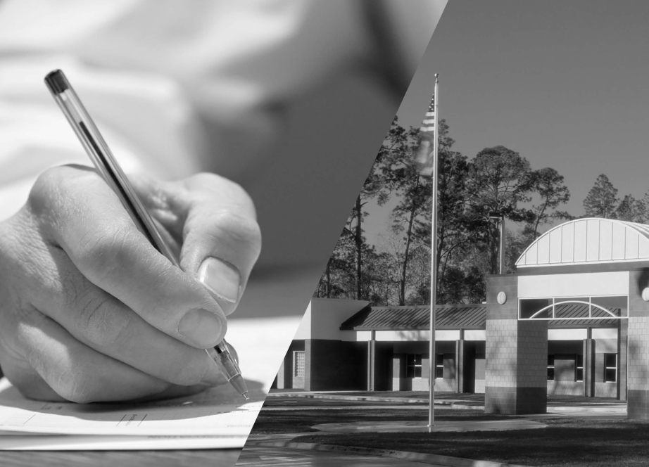 A hand holding a pencil and writing on paper alongside a public health department buildiing