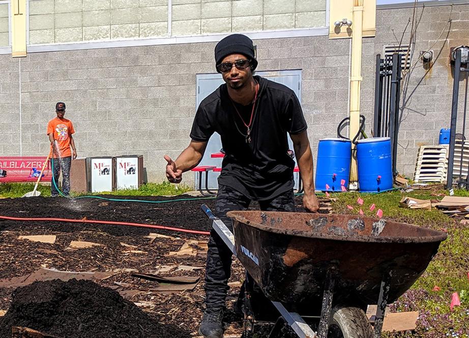 Community members and team members working in a community garden in Camden, NJ