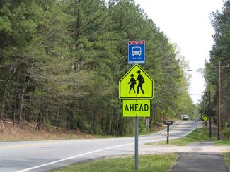A street with a school crossing sign